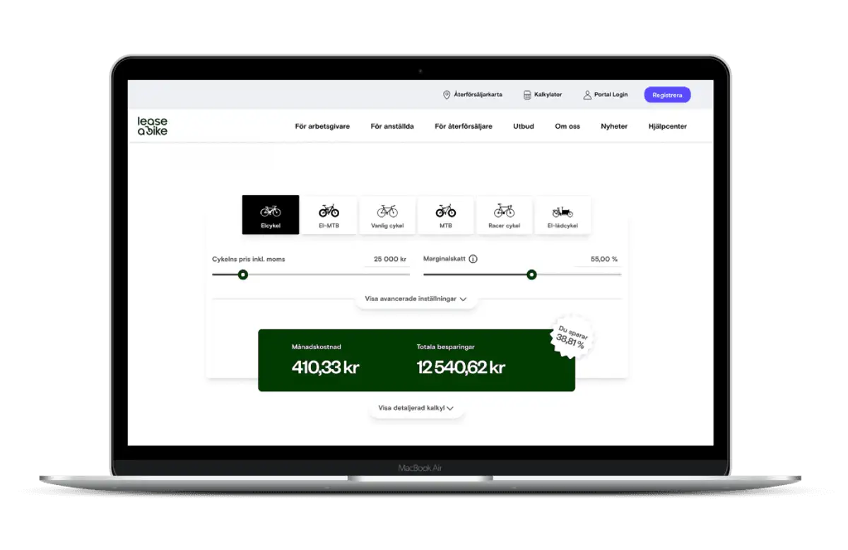 Man with Kalkhoff bike is standing in front of dark wall.